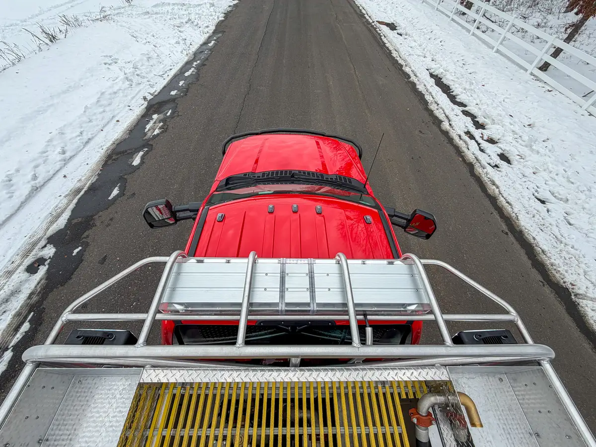 Top deck looking forward over red cab roof and side rails.